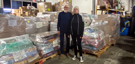 Image of Tom and Holly standing with the 16 pallet load