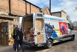 Image of Team Ukraine using their van to deliver relief goods.